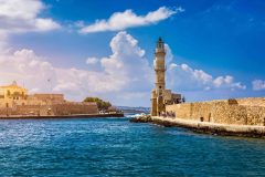 Panorama of venetian harbour waterfront and lighthouse in old harbour of Chania, Crete, Greece. Old venetian lighthouse in Chania, Greece. Lighthouse of the old Venetian port in Chania, Greece.